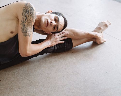 A man focusing on balance exercises in a bright studio